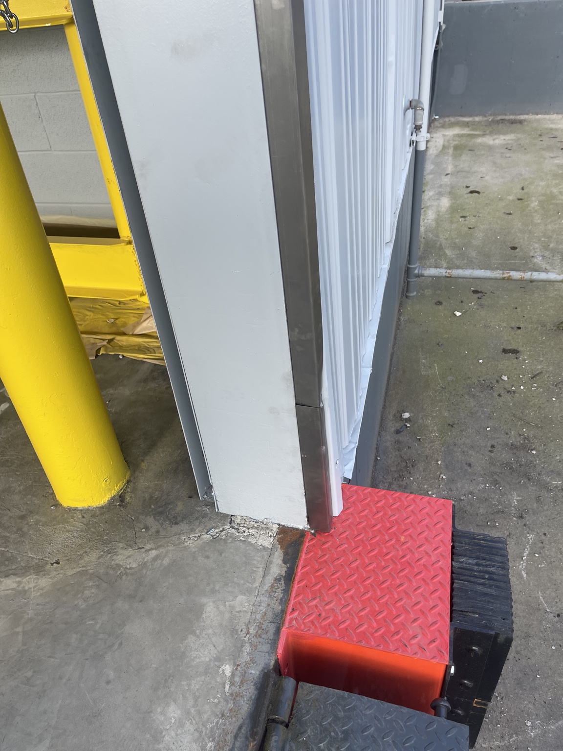 Detailed commercial metal painting near a loading dock